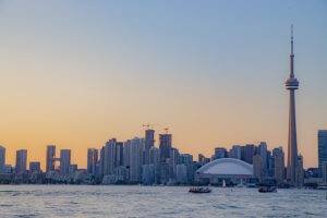 Sunset view of Toronto construction and water taxi in lake Ontario